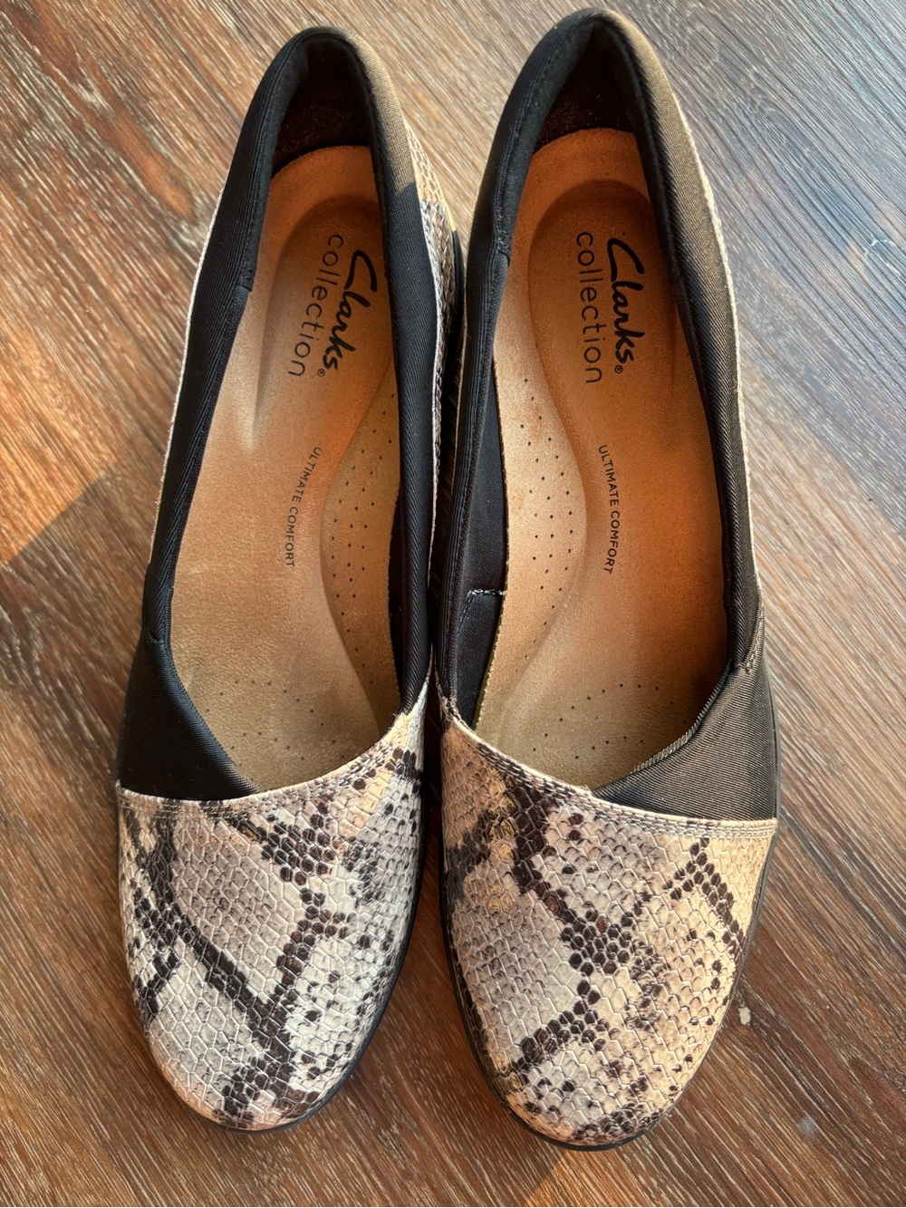 Clarks Women’s Black and Snake-Print Slip-On Flats